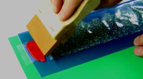 Use a Squeegee to Drag Paint Across Stencil